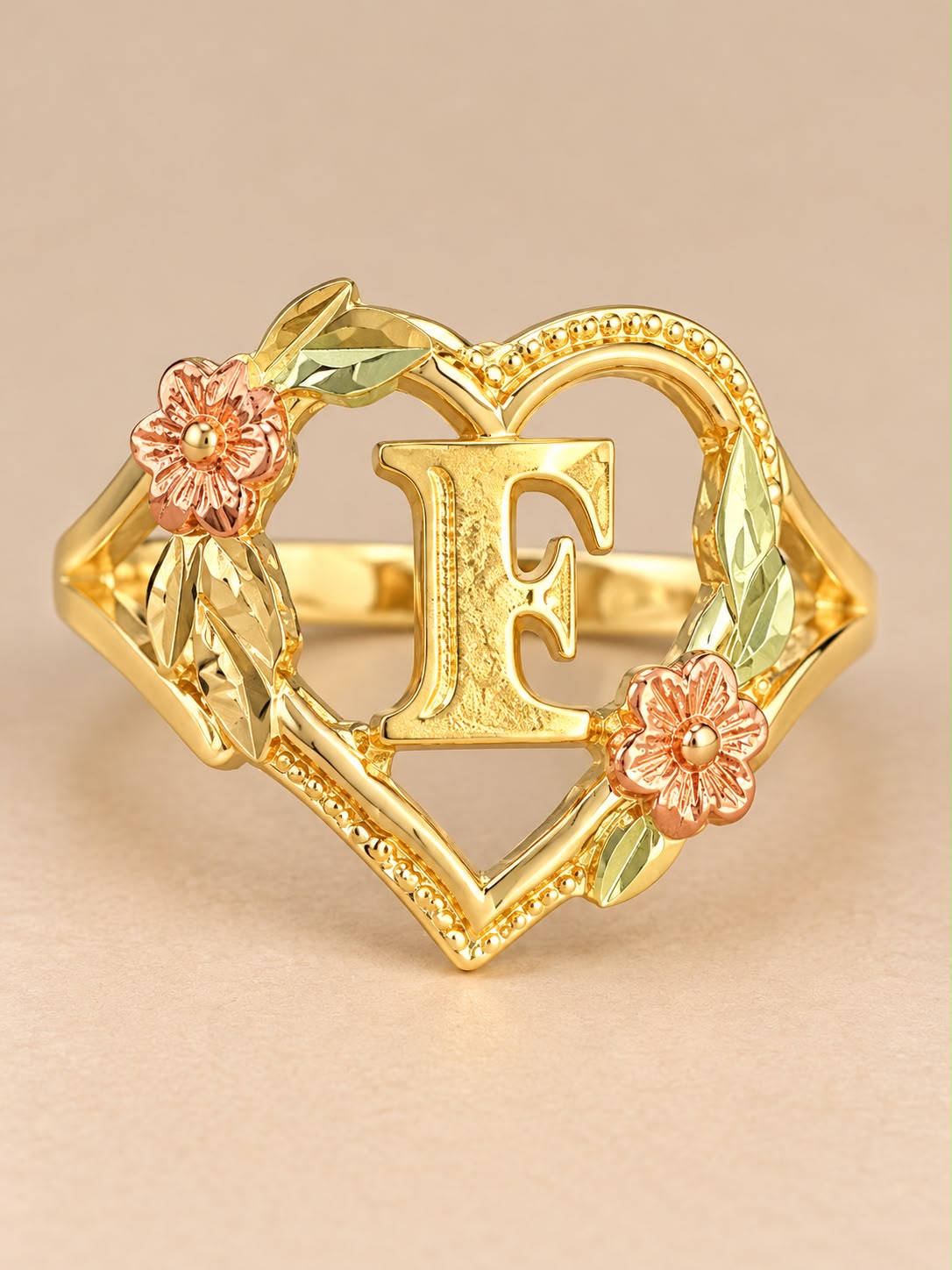 Beautiful 10K Yellow Gold Letter F Initial Ring featuring an elegant open-heart design with delicate rose gold-tone flowers and detailed leaf accents.