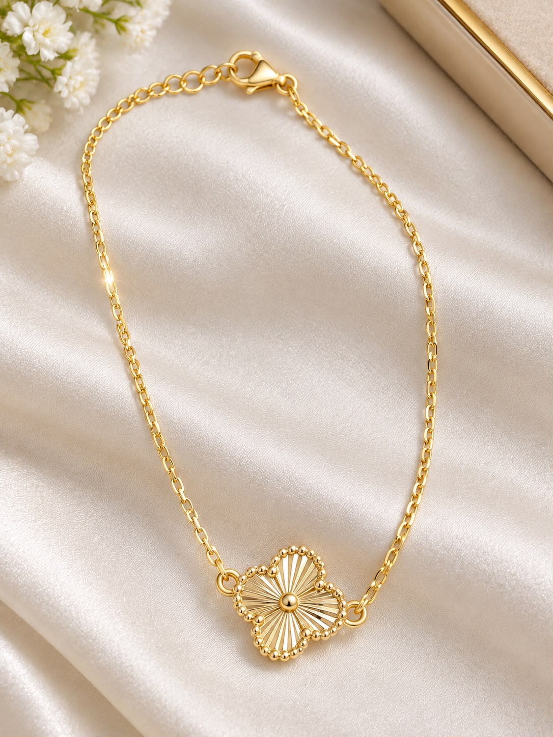 14K Yellow Gold Flower Anklet featuring an elegant floral centerpiece and a classic polished chain.
